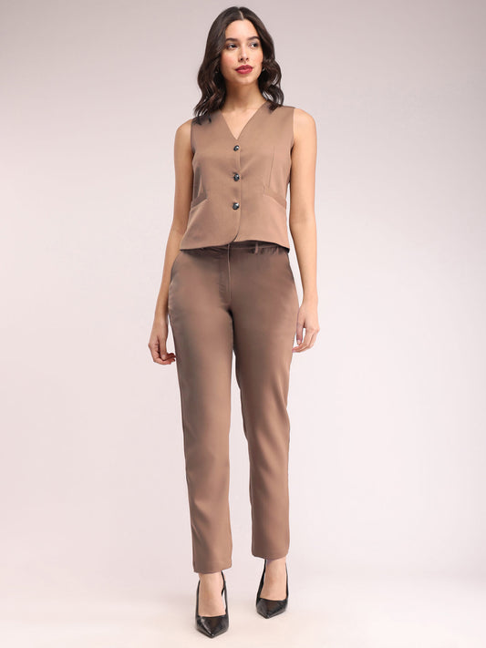 A model wearing a brown waistcoat and trousers co-ord set with a relaxed fit, V-neck, and buttoned waistcoat. The trousers are straight fit with two pockets. FableStreet
