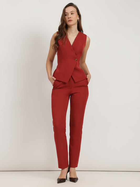 Woman wearing a red co-ord suit on a white background