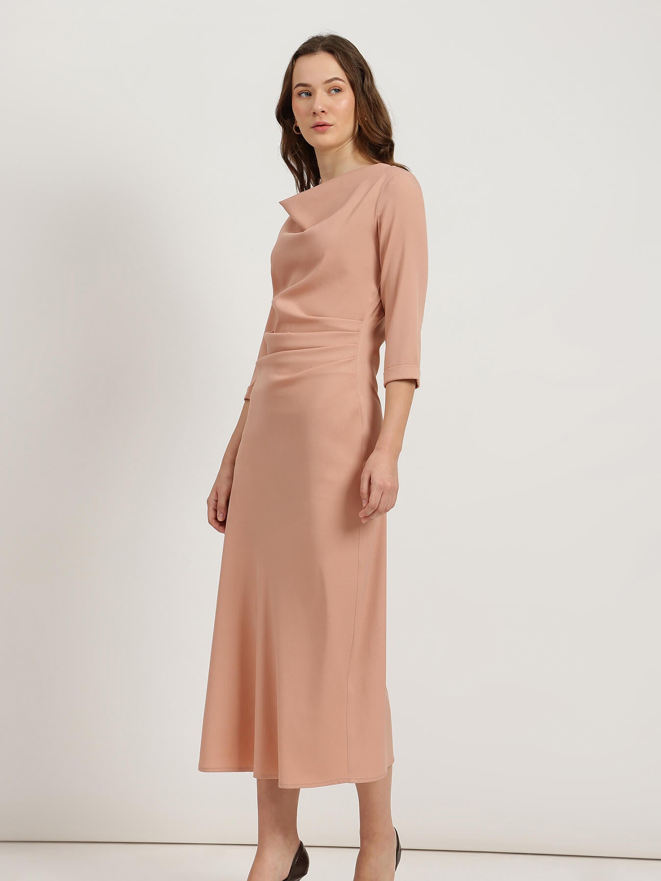 Woman wearing a pink dress against a white background