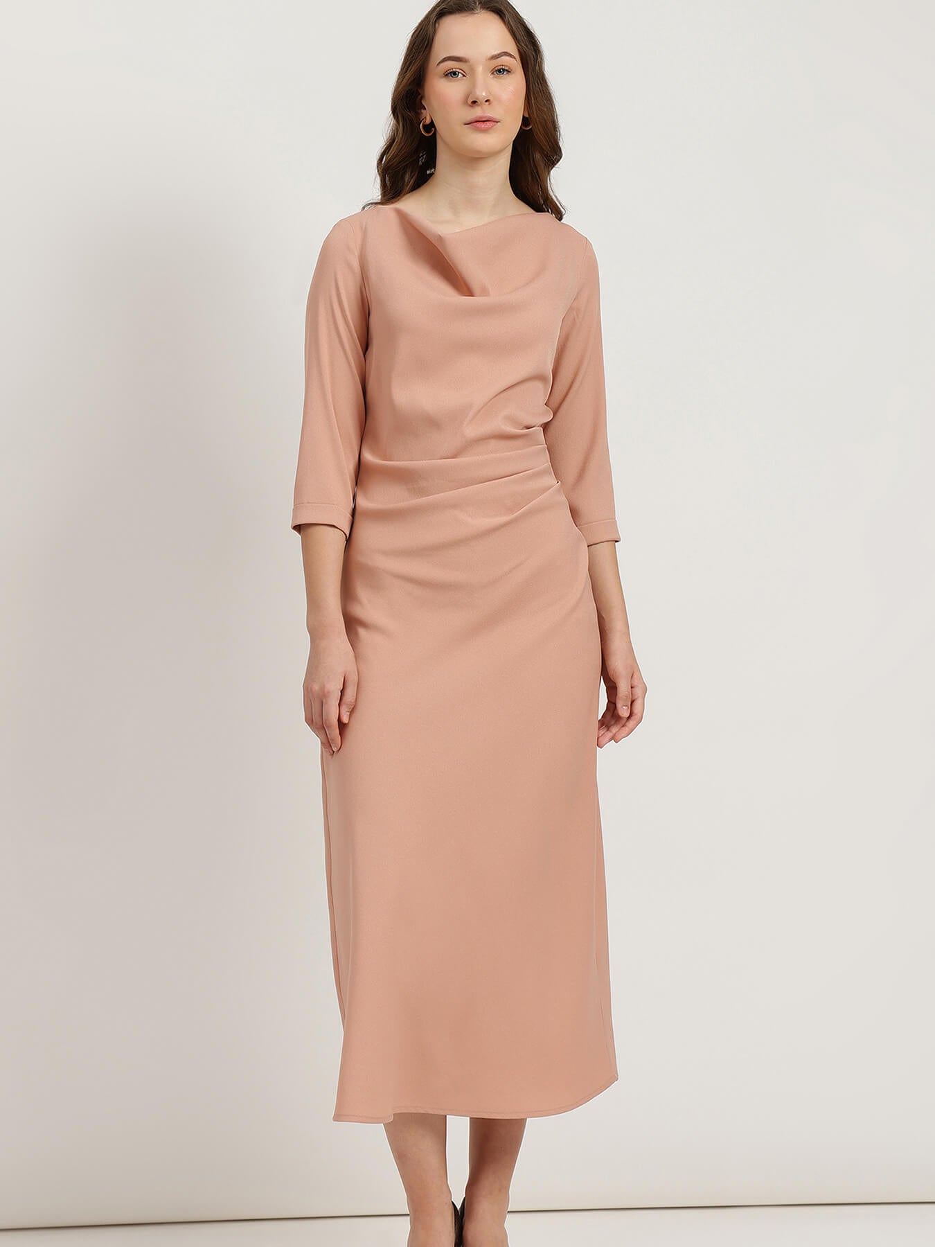 Woman wearing a pink dress against a white background