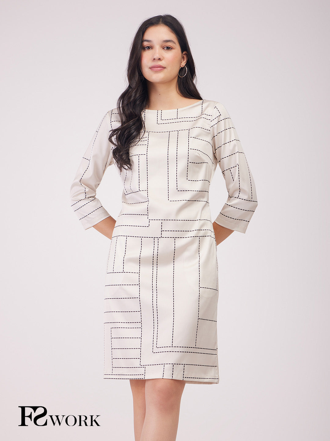 Woman wearing a patterned dress with 'FS Work' branding on a white background