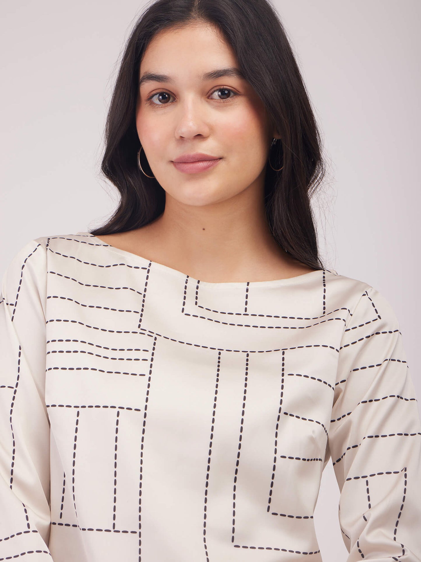 Woman wearing a patterned dress with 'FS Work' branding on a white background