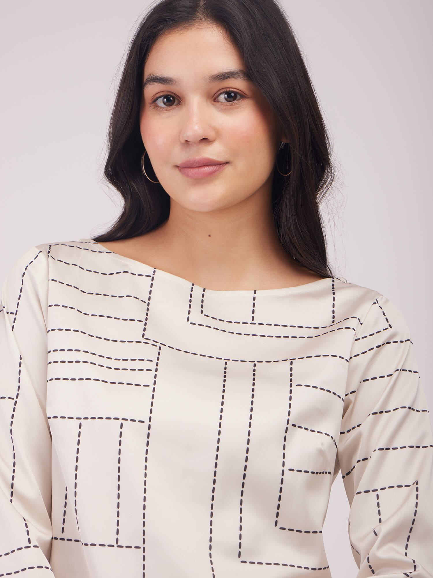 Woman wearing a patterned dress with 'FS Work' branding on a white background