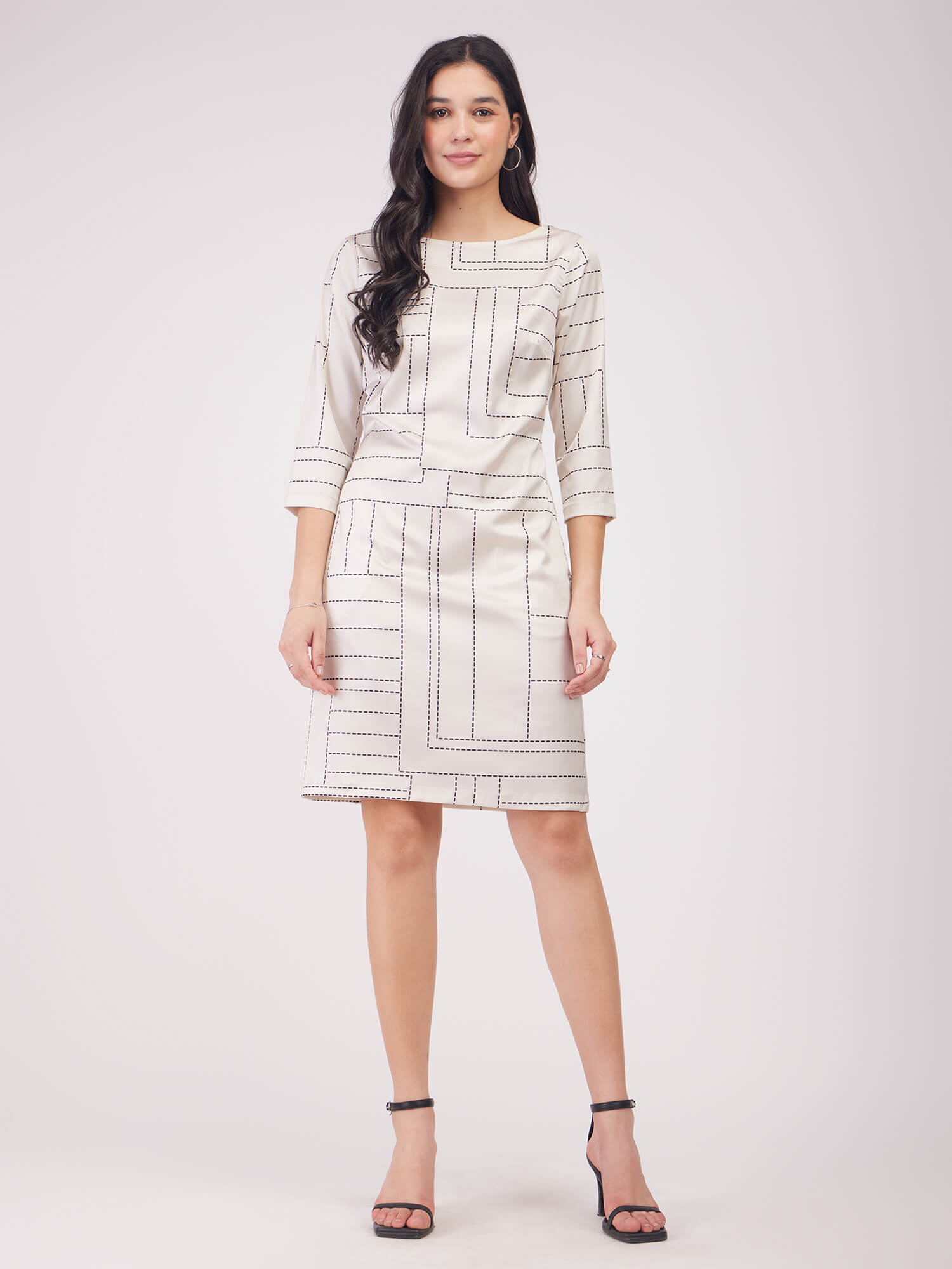 Woman wearing a patterned dress with 'FS Work' branding on a white background