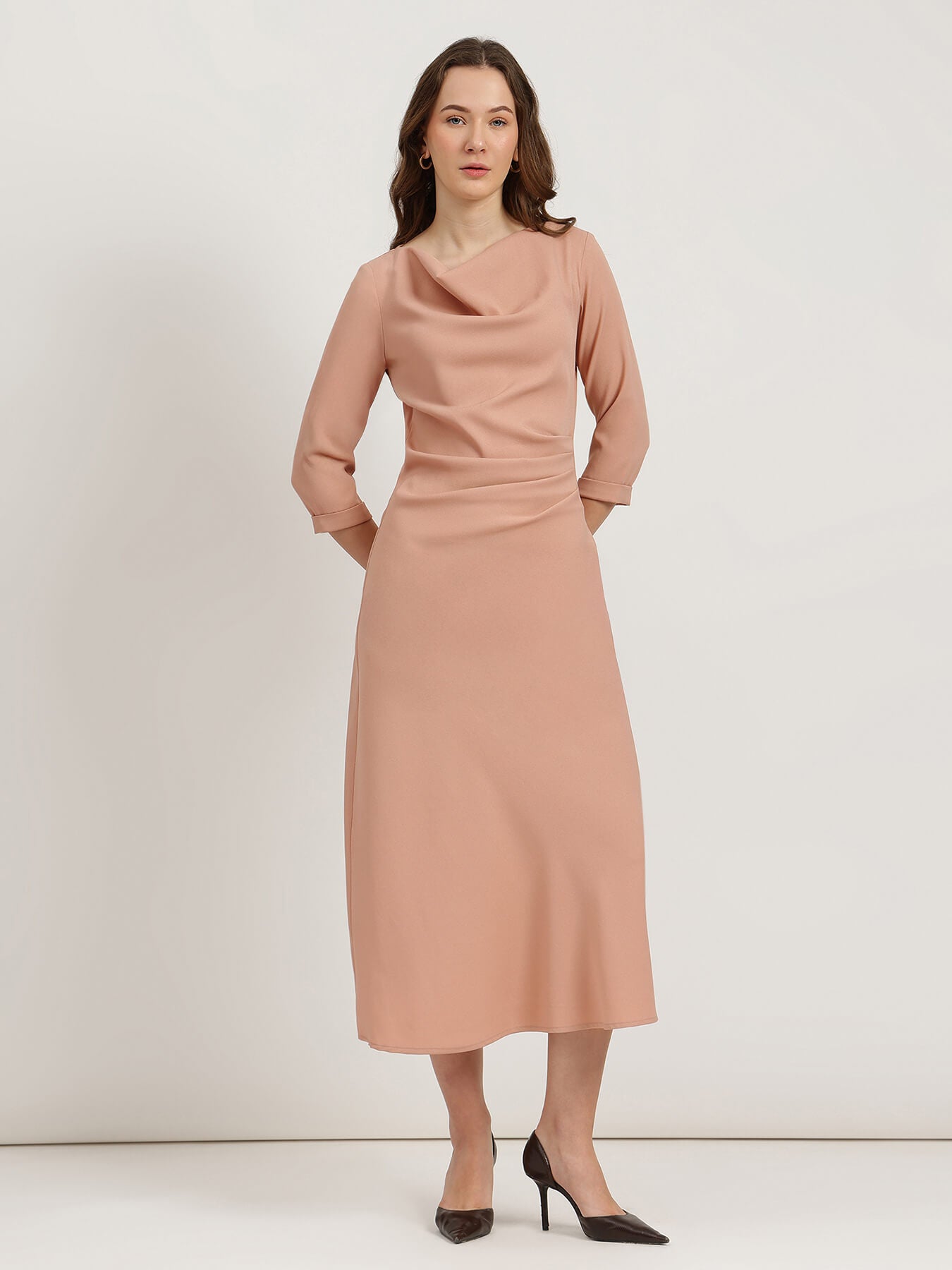 Woman wearing a pink dress against a white background